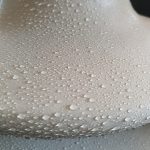 Close up of Si-Coat 570 HVIC showing water droplets beading on the silicone surface, demonstrating hydrophobicity and self cleaning properties
