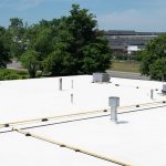 SI-COAT 461 RC white silicone roof coating applied to industrial roof surface