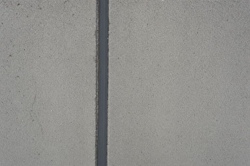 Expansion joint sealer applied to a concrete pavement joint